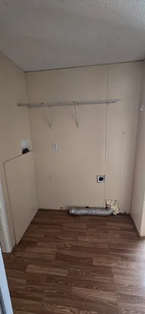 a view of a room with wooden floor