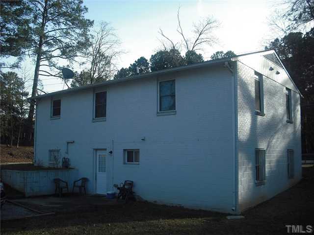 2209 Rock Quarry Road Raleigh, NC 27610 - Photo 1 of 25 a side view of a house with a yard