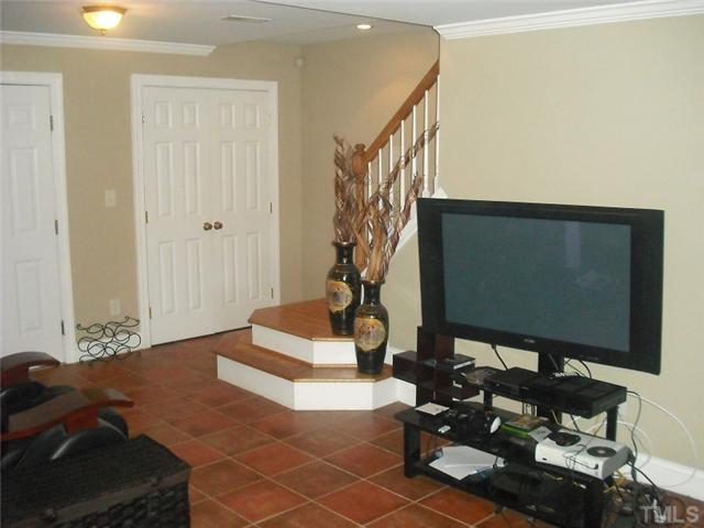 2209 Rock Quarry Road Raleigh, NC 27610 - Photo 11 of 25 a living room with furniture and a flat screen tv