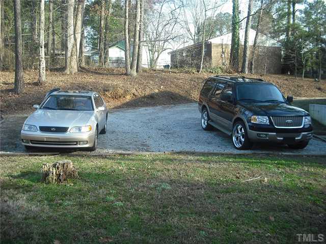 2209 Rock Quarry Road Raleigh, NC 27610 - Photo 22 of 25 a car parked in front of a house