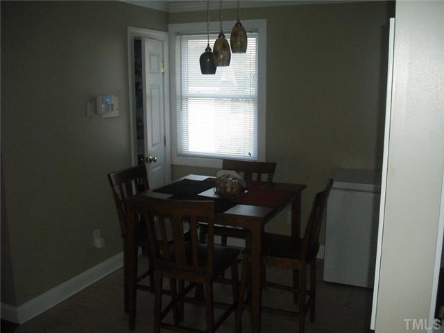 2209 Rock Quarry Road Raleigh, NC 27610 - Photo 9 of 25 a view of a dining room with furniture and window