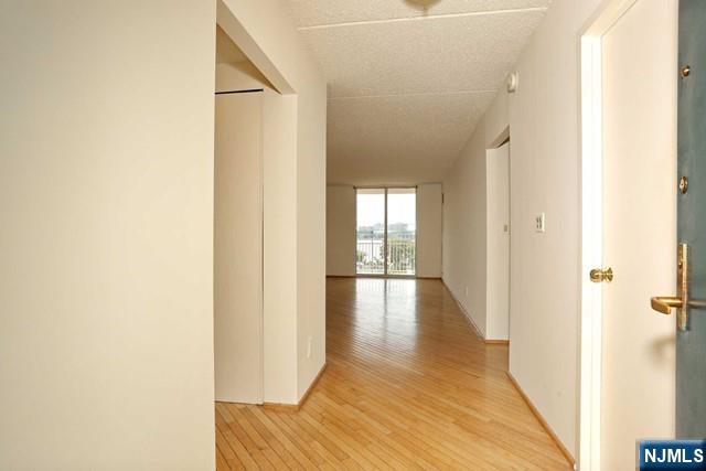 1055 River, Unit 506 Edgewater, NJ 07020 - Photo 3 of 25 a view of a hallway with wooden floor
