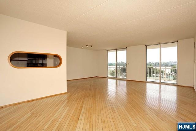 1055 River, Unit 506 Edgewater, NJ 07020 - Photo 4 of 25 a view of a livingroom with wooden floor