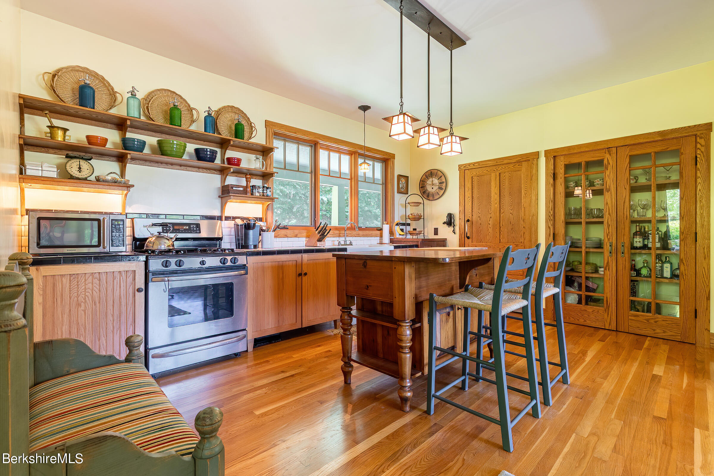 99 Hupi Road Monterey, MA 01245 - Photo 17 of 43 a kitchen with stainless steel appliances a stove a sink dishwasher and a dining table with wooden floor