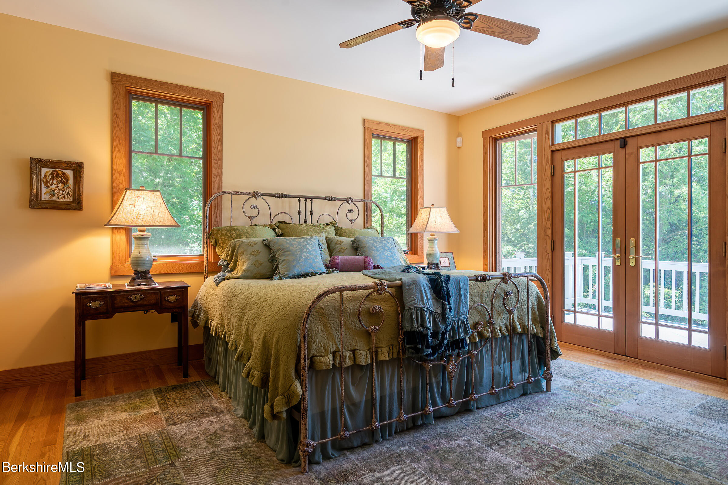 99 Hupi Road Monterey, MA 01245 - Photo 20 of 43 a bedroom with a bed and a chandelier