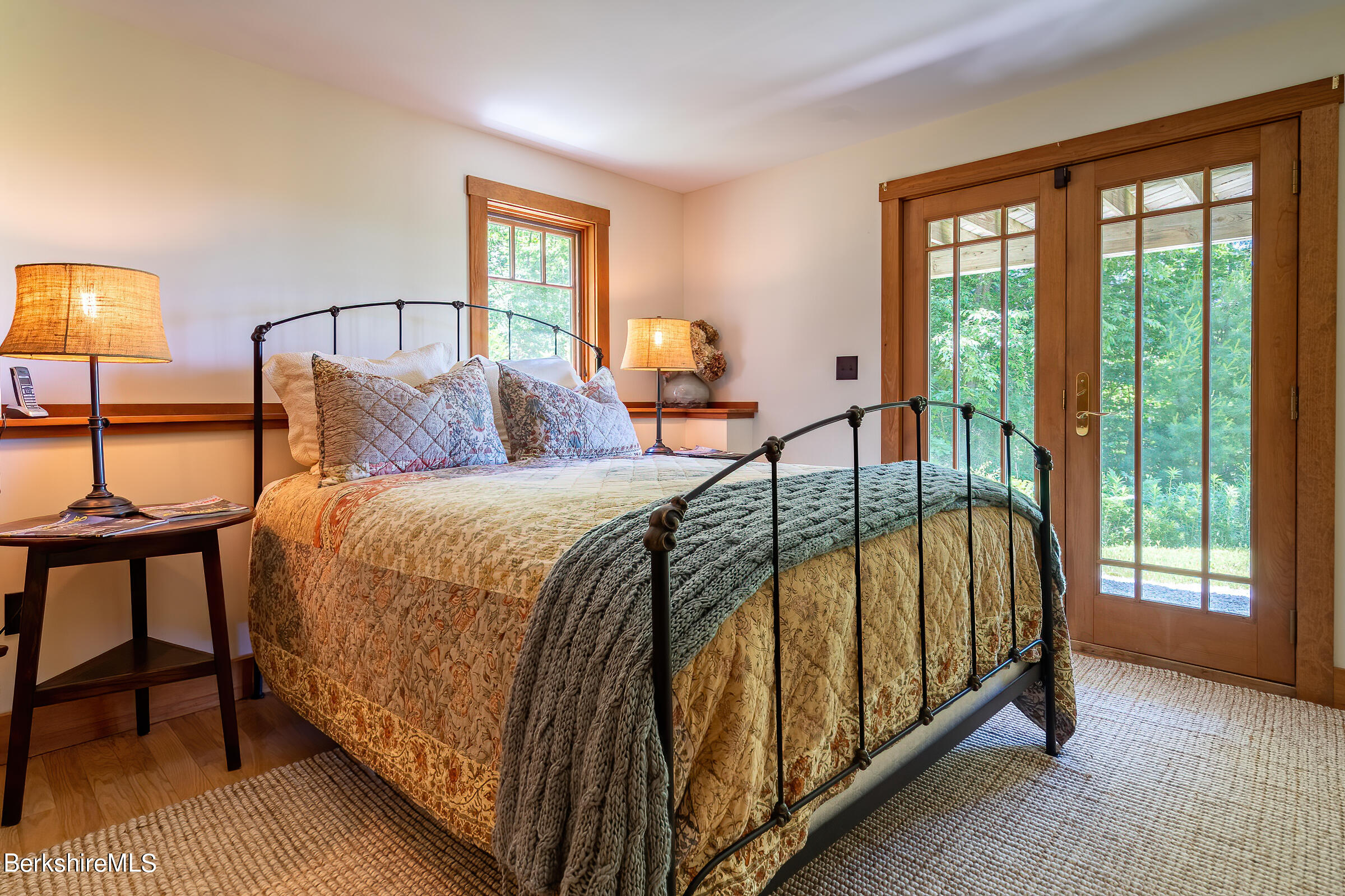 99 Hupi Road Monterey, MA 01245 - Photo 26 of 43 a bed sitting in a bedroom next to a window