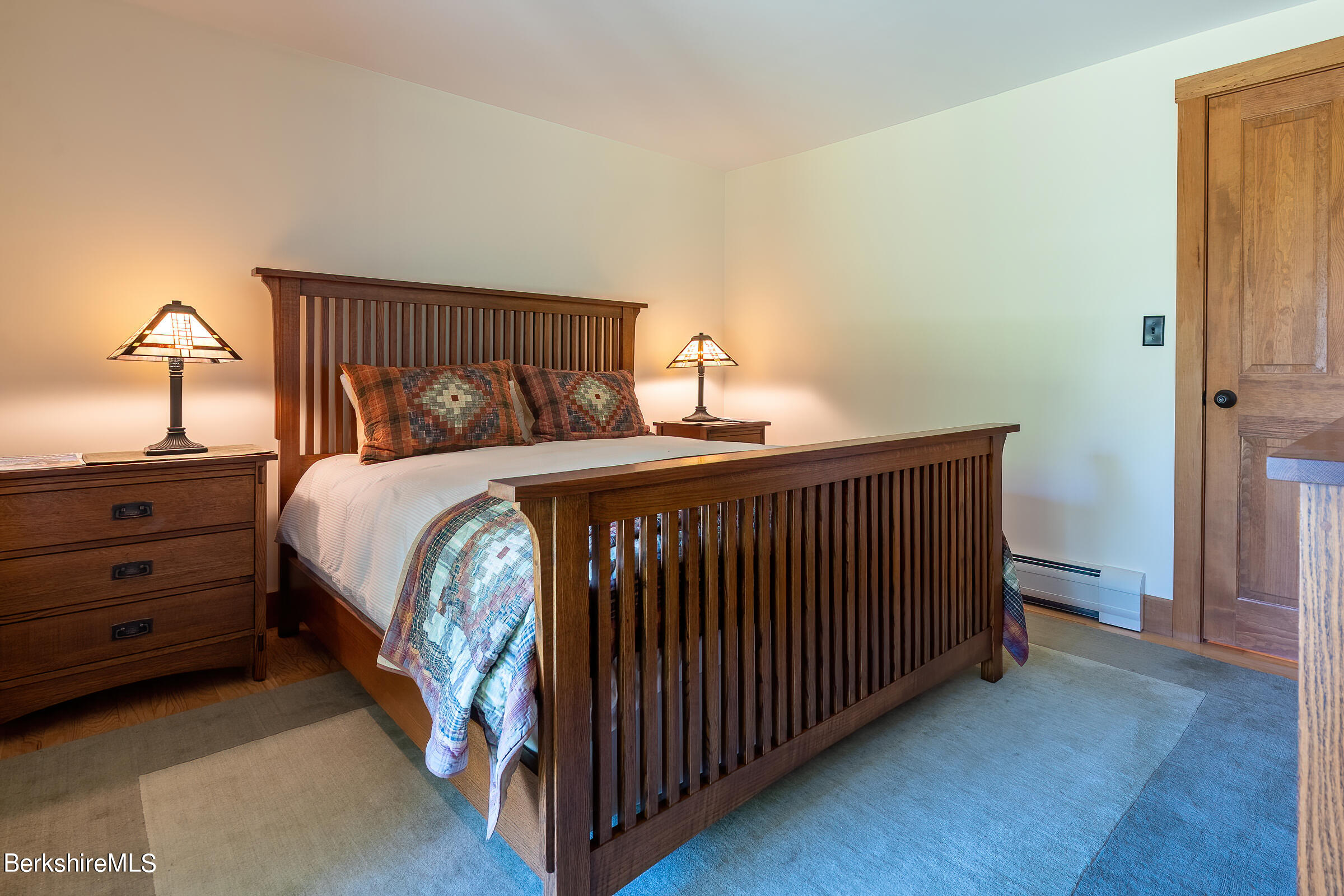 99 Hupi Road Monterey, MA 01245 - Photo 28 of 43 a bedroom with a bed and a mirror