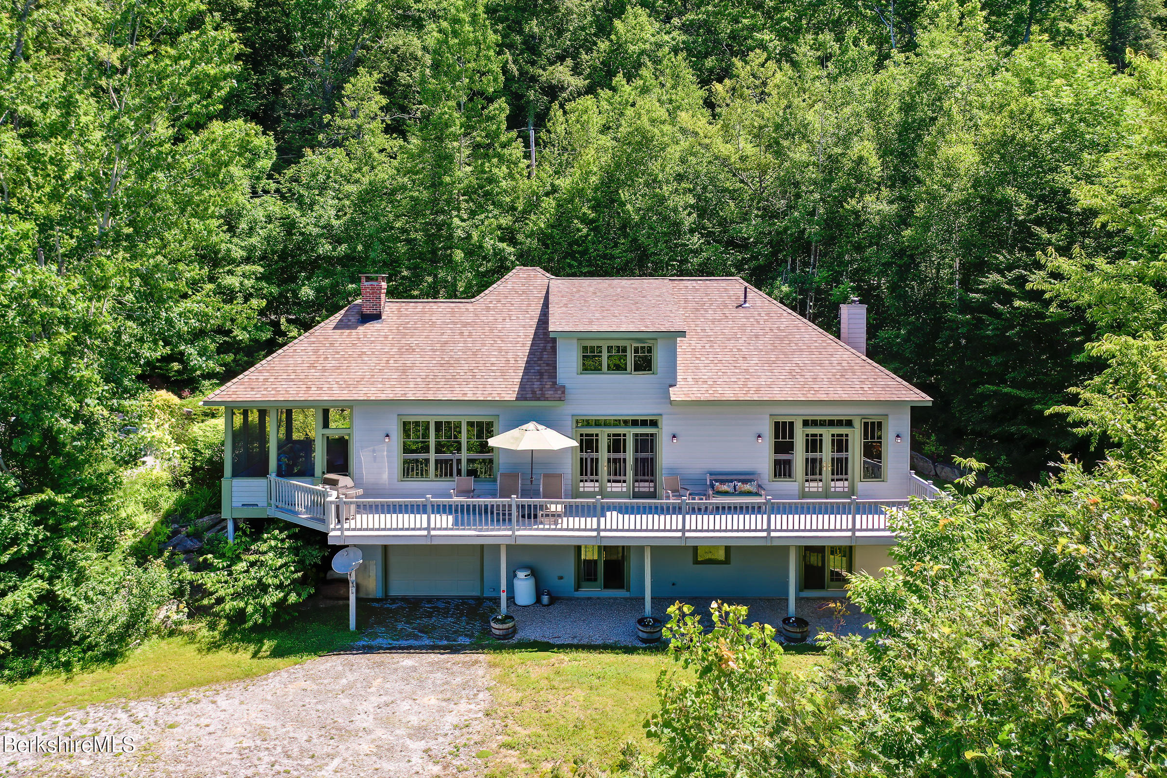 99 Hupi Road Monterey, MA 01245 - Photo 35 of 43 a front view of a house with a garden and balcony
