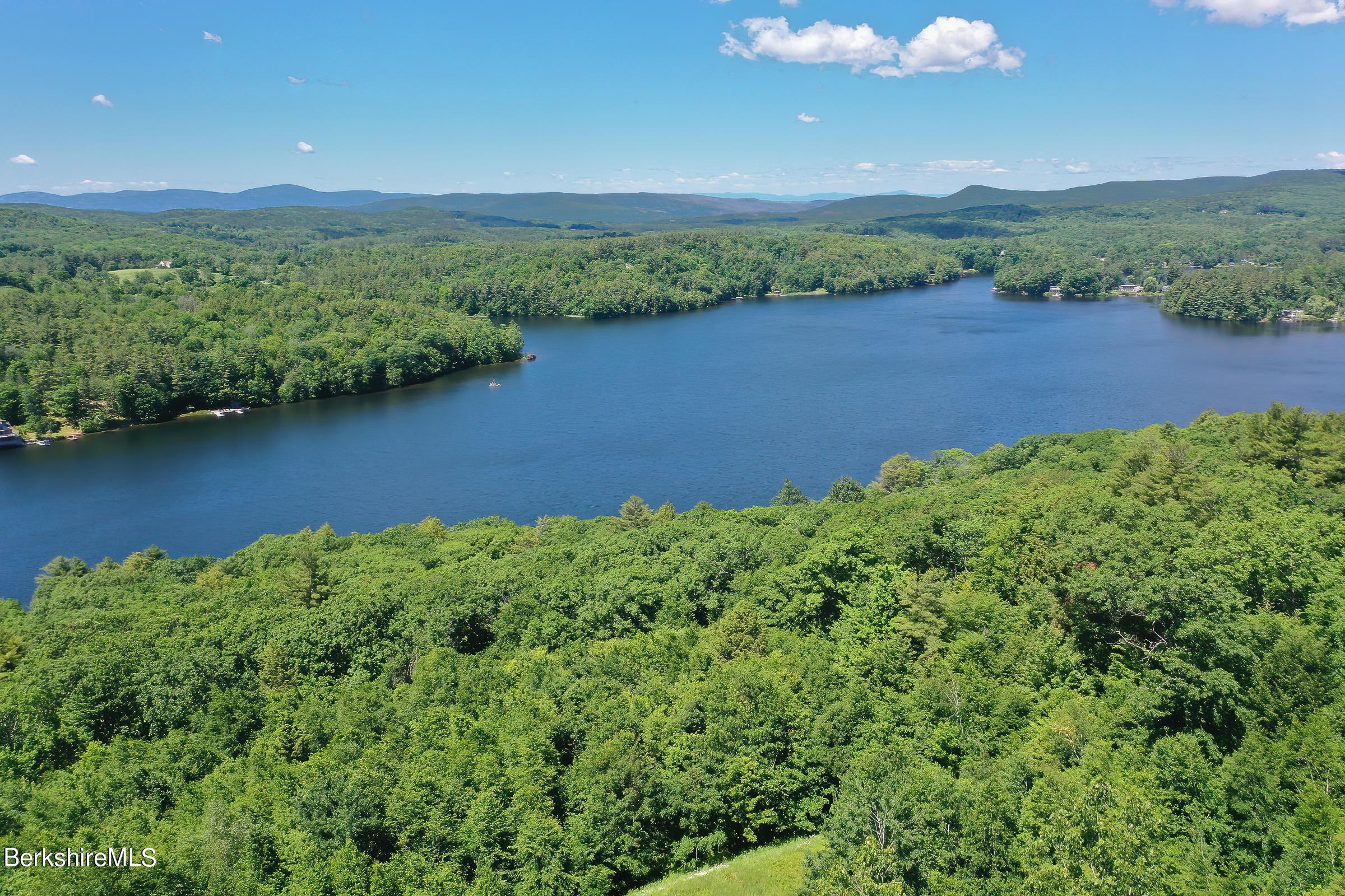 99 Hupi Road Monterey, MA 01245 - Photo 41 of 43 a view of a lake with a mountain in the background