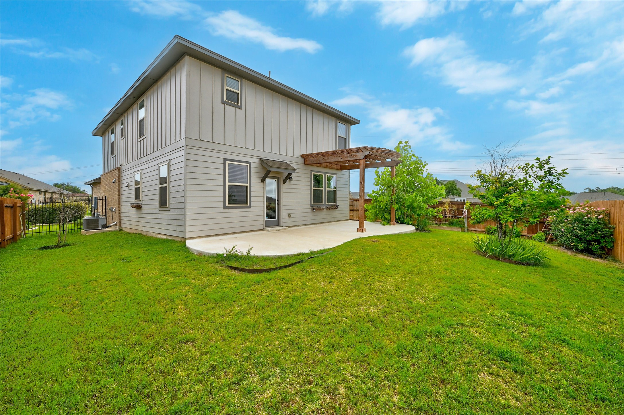 101 Lambert Street Leander, TX 78641 - Photo 29 of 33 A spacious lawn provides ample outdoor living space with a charming patio for entertaining.