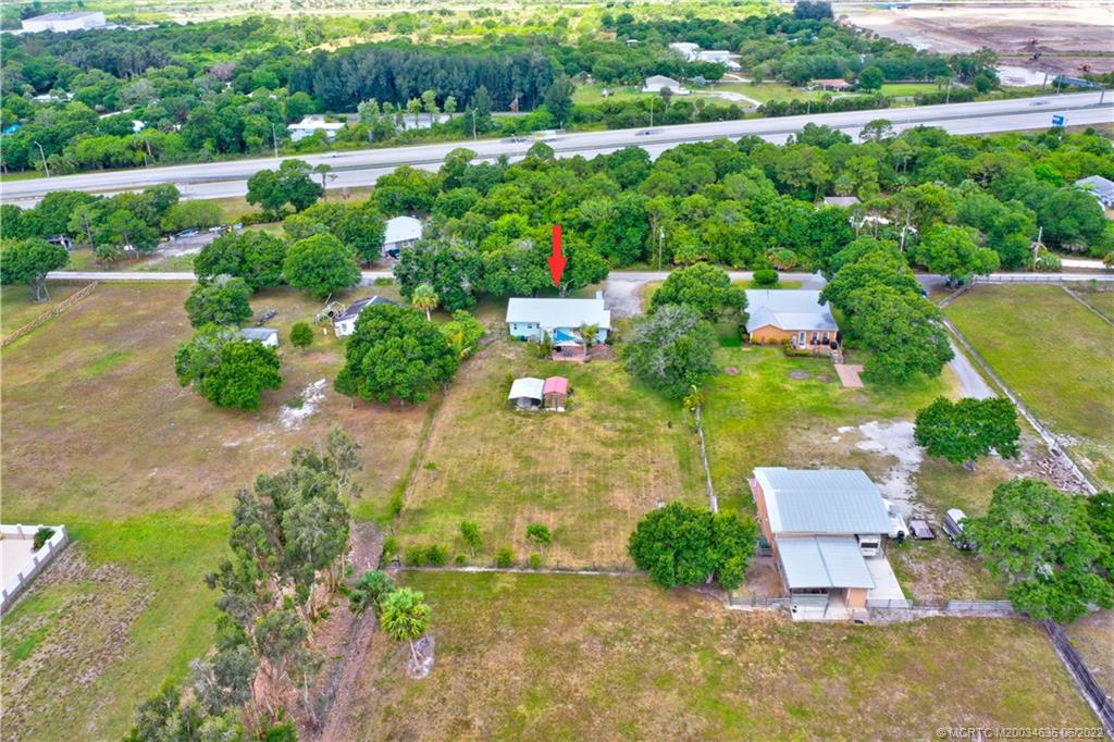 6385 Peterson Road Fort Pierce, FL 34947 - Photo 53 of 58 an aerial view of a house with a garden and lake view