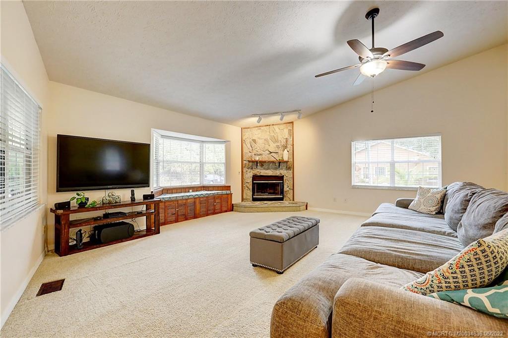 6385 Peterson Road Fort Pierce, FL 34947 - Photo 8 of 58 a living room with furniture and a flat screen tv