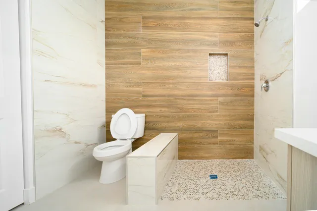 a bathroom with a toilet and a shower