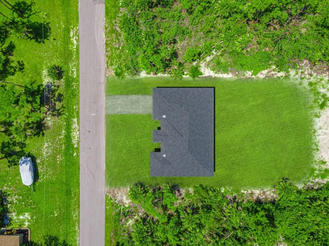 an aerial view of a house with a yard