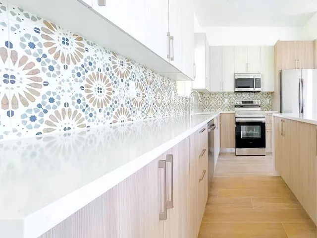 a large white kitchen with a stove