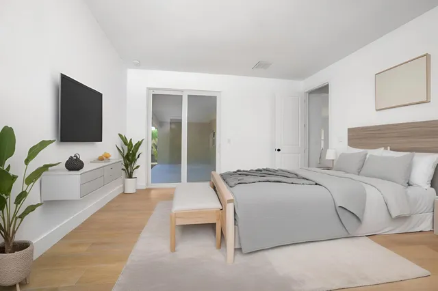 a spacious bedroom with a bed and a couch