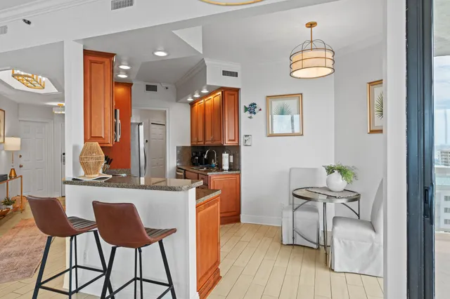 a kitchen with stainless steel appliances a dining table and chairs