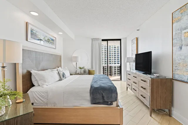 a bedroom with a bed and a flat screen tv in it