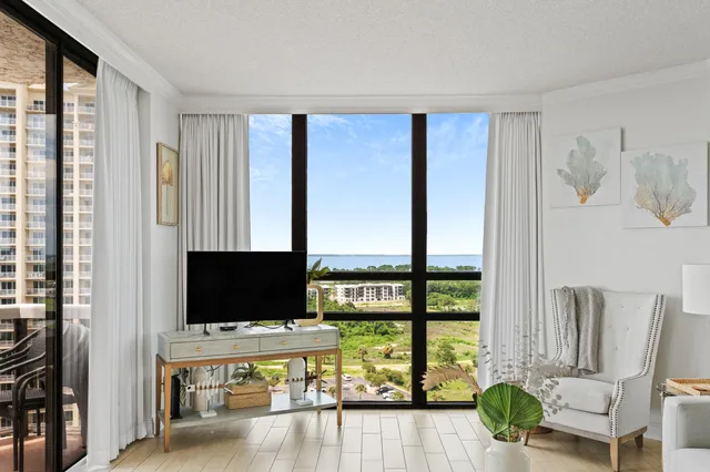 a living room with furniture tv and a window