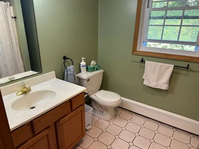 a bathroom with a sink mirror and toilet