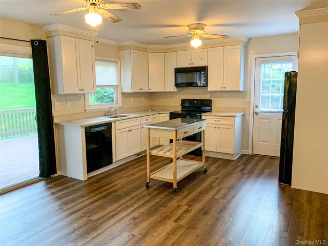 a kitchen with wooden floors and white appliances