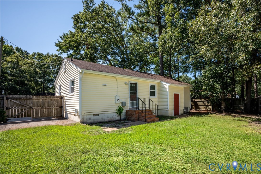 3530 Glisson Road Richmond, VA 23237 - Photo 17 of 17 Yellow siding exterior with white trim, a brown sh