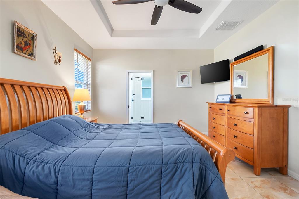 10232 Andover Point Circle Orlando, FL 32825 - Photo 13 of 33 a bedroom with a bed and flat screen tv