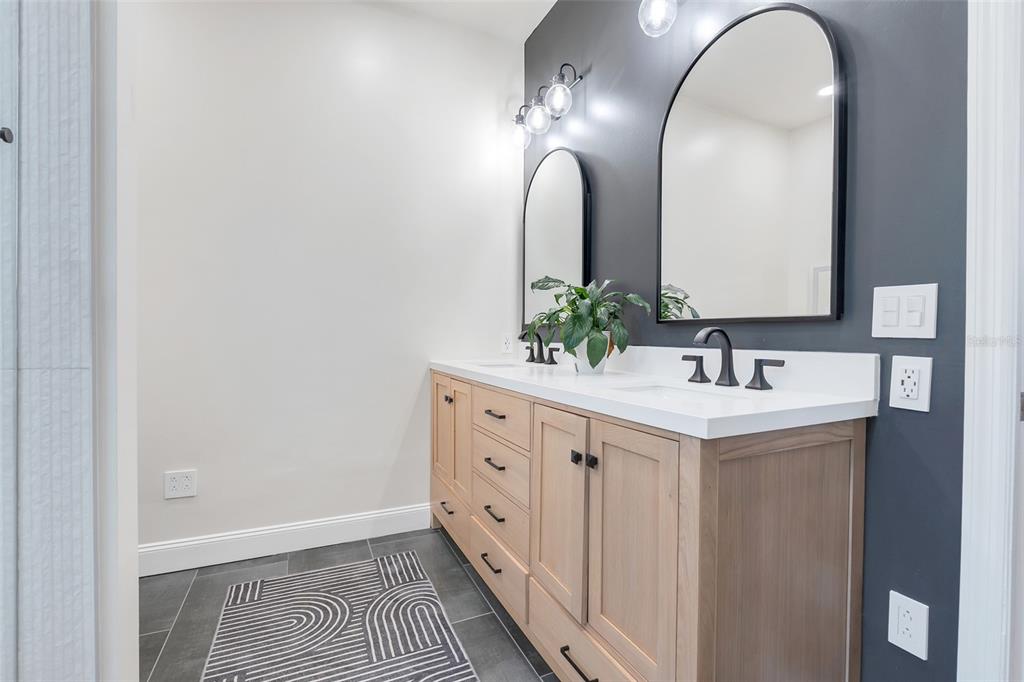 10232 Andover Point Circle Orlando, FL 32825 - Photo 14 of 33 a spacious bathroom with a double vanity sink and a mirror