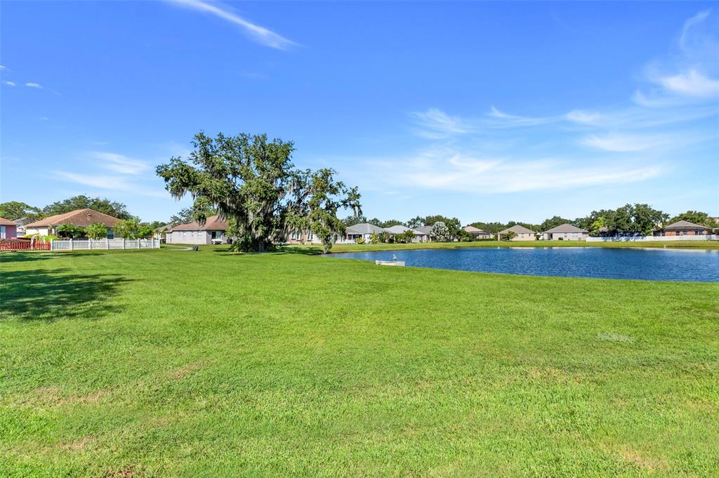 10232 Andover Point Circle Orlando, FL 32825 - Photo 27 of 33 a view of a lake with houses in the background