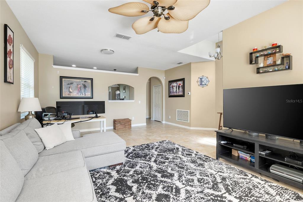 10232 Andover Point Circle Orlando, FL 32825 - Photo 3 of 33 a living room with furniture and a flat screen tv