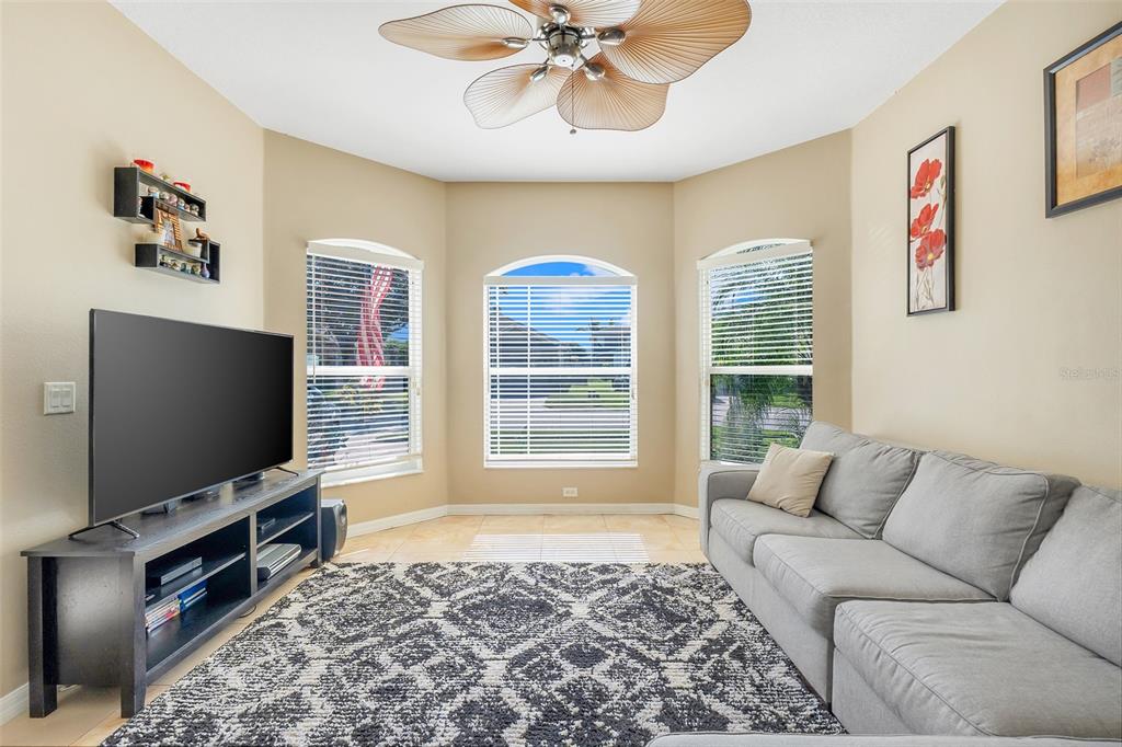 10232 Andover Point Circle Orlando, FL 32825 - Photo 4 of 33 a living room with furniture and a flat screen tv