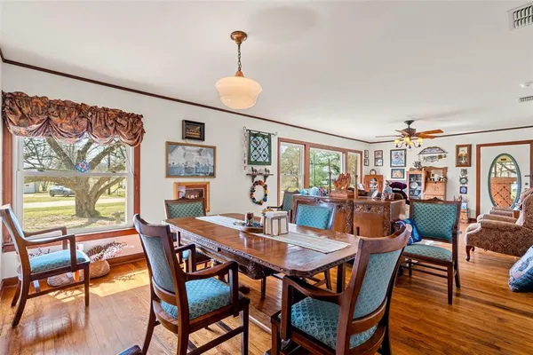 a view of a dining room with furniture and wooden floor