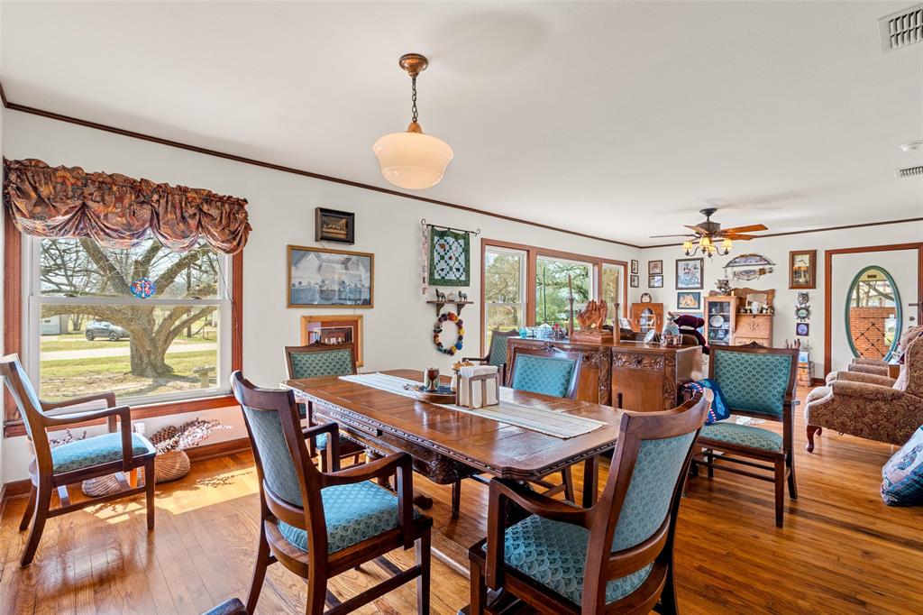 609 East Quitman Street Alba, TX 75410 - Photo 12 of 34 a view of a dining room with furniture and wooden floor
