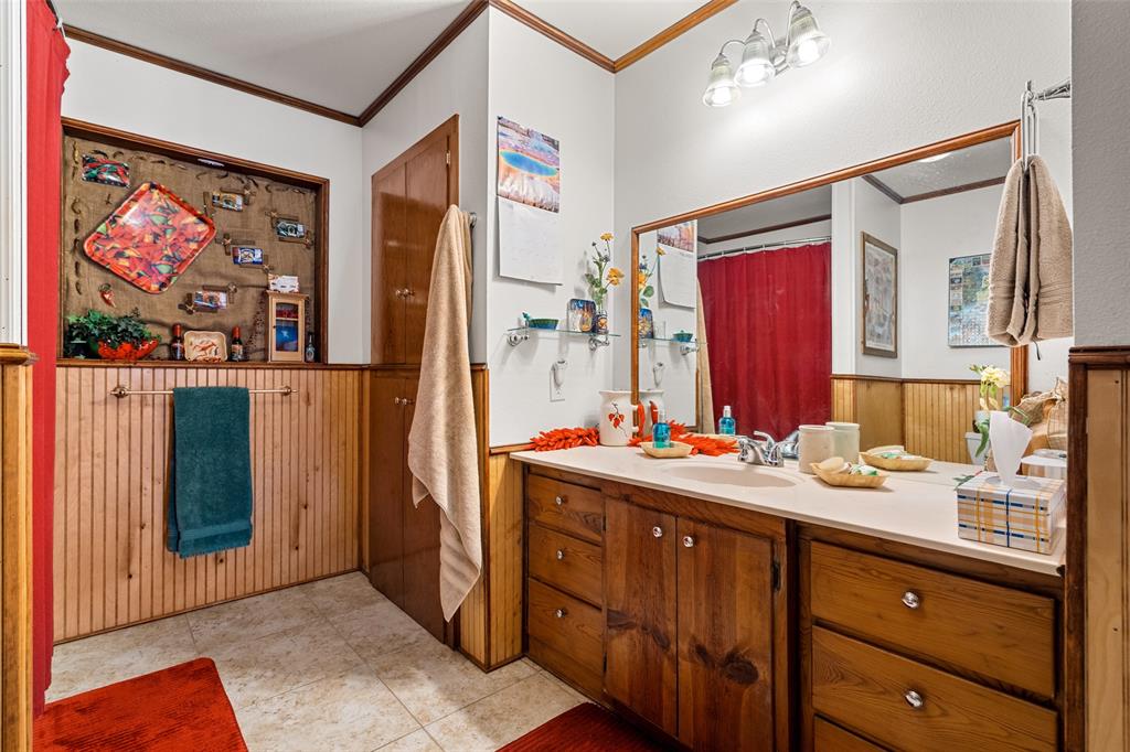 609 East Quitman Street Alba, TX 75410 - Photo 18 of 34 a bathroom with a sink a vanity and a mirror