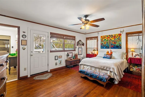 a bedroom with a bed and a large window