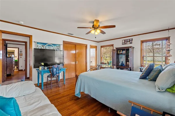 a bedroom with a bed and a flat screen tv