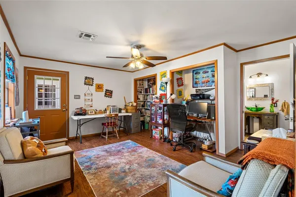a living room with furniture a wooden floor and a window