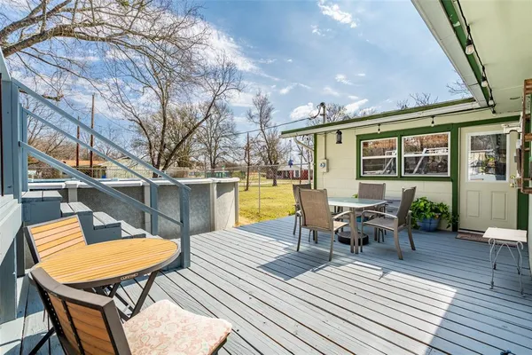 a view of a chairs and table in the patio with a barbeque