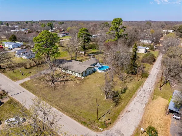 an aerial view of residential houses with outdoor space