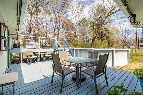 a view of a dinning table and chairs on the roof deck