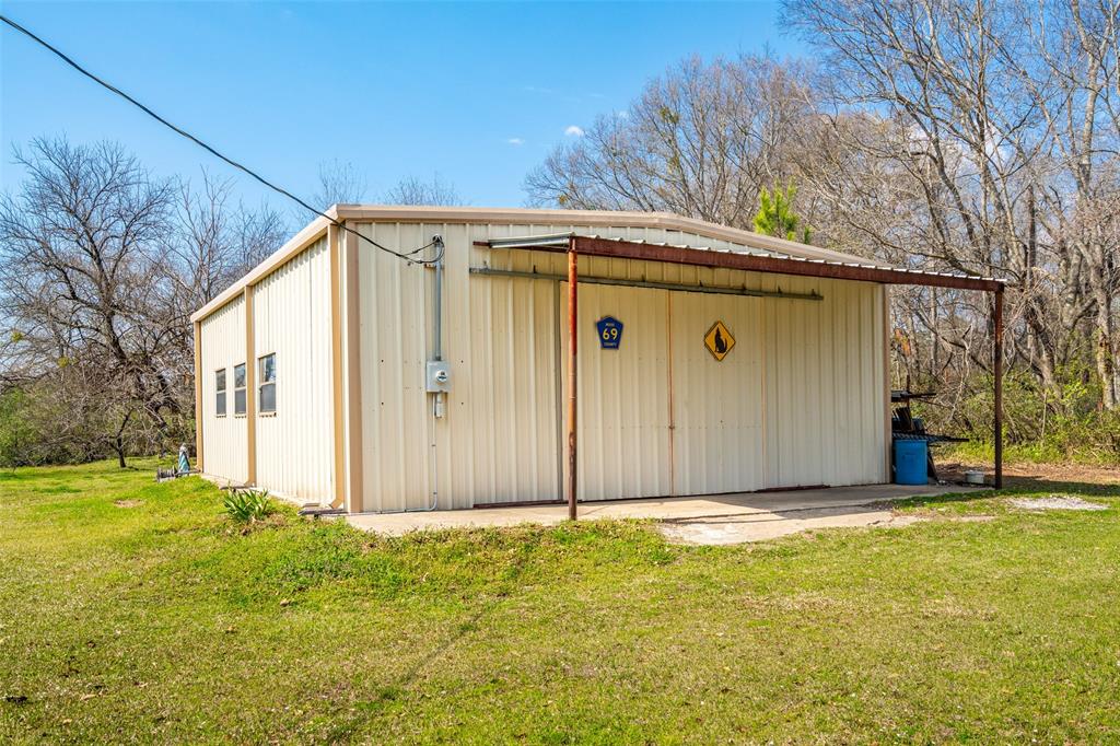 609 East Quitman Street Alba, TX 75410 - Photo 33 of 34 a view of a house with backyard and tree