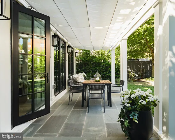 a view of a porch with chairs and backyard