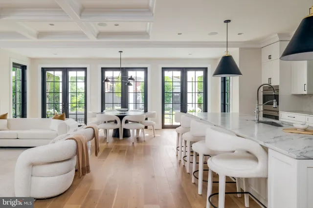 a living room with furniture a flat screen tv and a large window