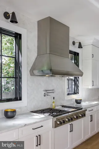 a kitchen with stainless steel appliances a stove and a more cabinets