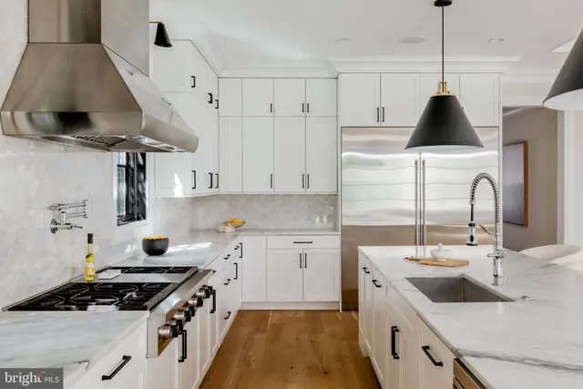 a kitchen with stainless steel appliances a sink stove and cabinets