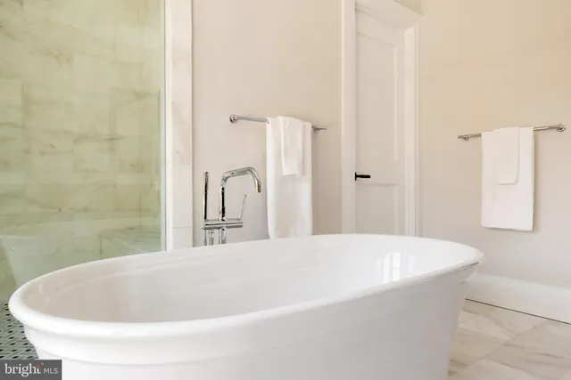 a bathroom with double sink and two mirror