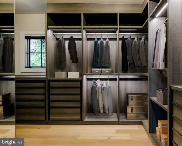 a view of a hallway with wooden floor and windows