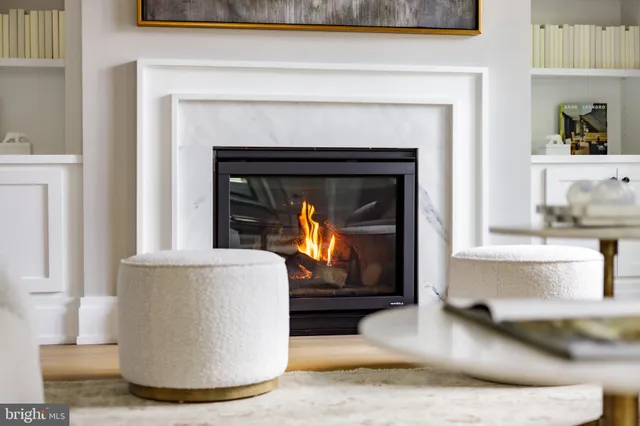 a living room with a fireplace and a fireplace