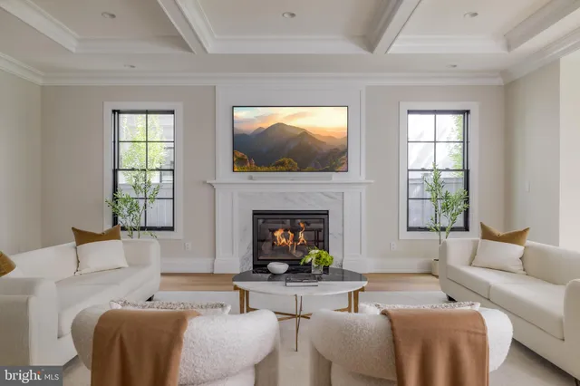 a living room with furniture a window and a fireplace