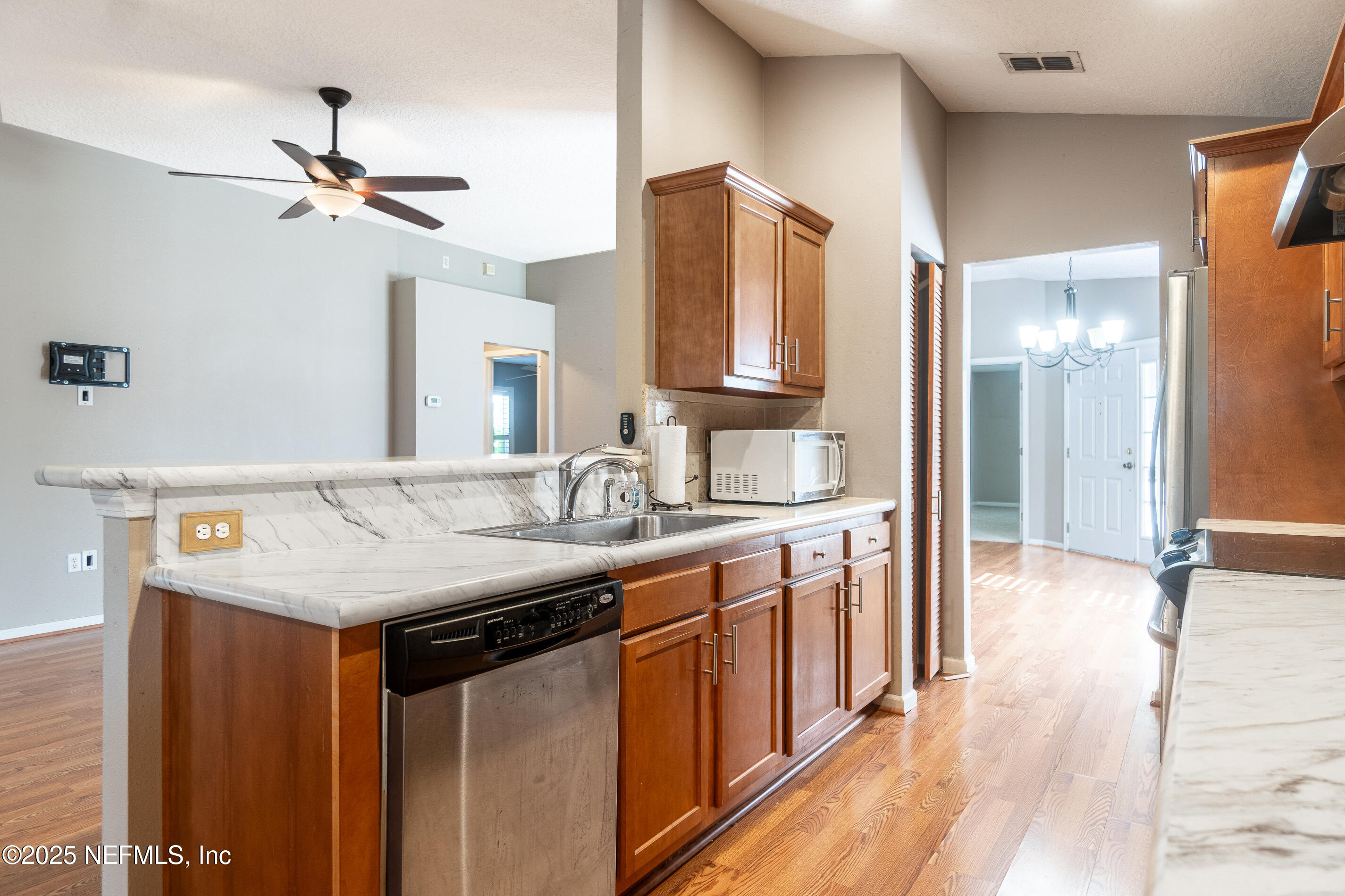 1325 Fairway Village Drive Fleming Island, FL 32003 - Photo 11 of 36 a kitchen with stainless steel appliances a sink and a refrigerator